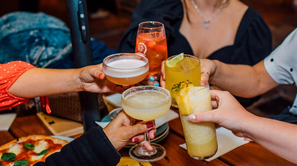 people cheersing cocktails